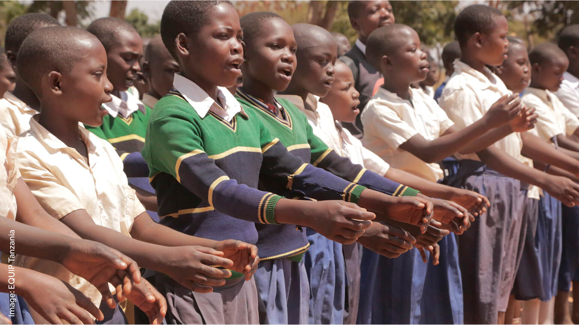 Tanzanian children in school uniform lined up and singing